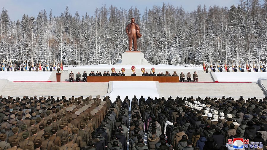 North Korean leader Kim Jong Un (C) attends a national meeting to celebrate 80th birth anniversary of chairman Kim Jong Il (in front of his statue) in Samjiyon city. Credit: AFP Photo