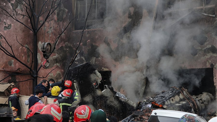 First responders work amid debris from the crashed fighter jet, in Tabriz, Iran, February 21, 2022. Credit: Mehr News/WANA (West Asia News Agency)/Reuters