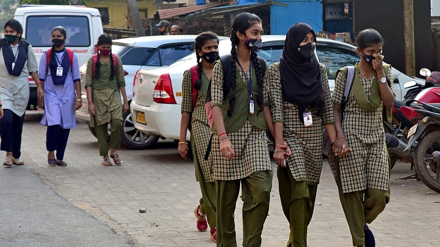 Girl students hold hands while walking to the Udupi Government PU college in Udupi. Credit: DH Photo/Irshad Mahammad