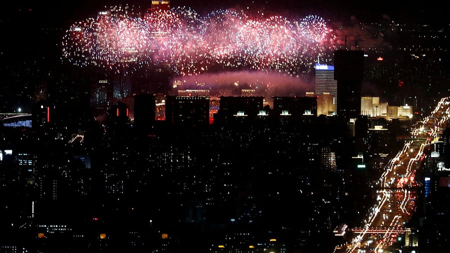 A general view of the city as fireworks explode over the National Stadium, also known as the Bird's Nest, at the end of the closing ceremony of the Beijing 2022 Winter Olympics, in Beijing, China February 20, 2022. Credit: Reuters Photo