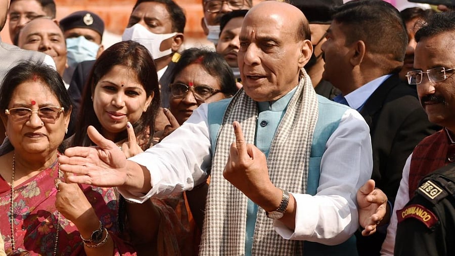 Defence Minister Rajnath Singh with his family after casting his vote at a polling station, during the fourth phase of UP Assembly polls, in Lucknow. Credit: PTI Photo