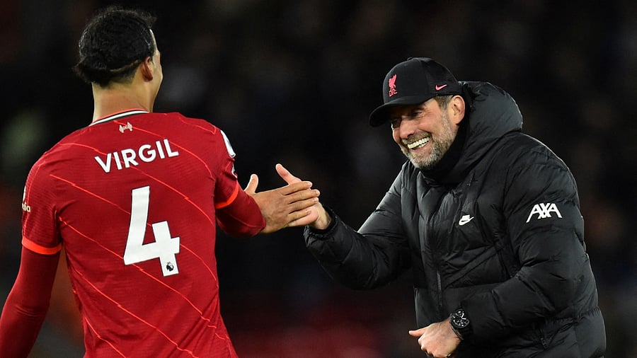 Liverpool's Virgil van Dijk and manager Juergen Klopp celebrate after the match. Credit: Reuters Photo