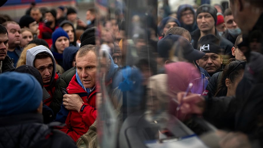 People struggle to get on a bus as they try to leave Kyiv, Ukraine. Credit: AP/PTI Photo