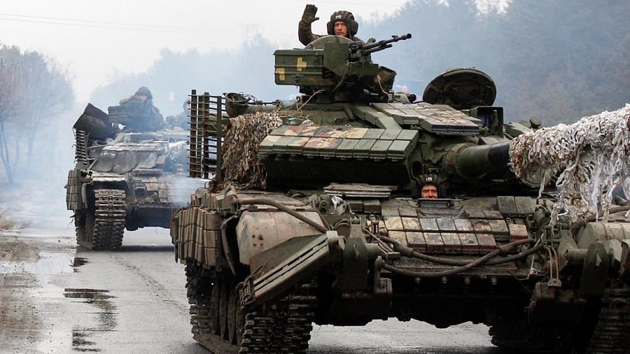 Ukrainian servicemen ride on tanks towards the front line with Russian forces in the Lugansk region of Ukraine. Credit: AFP Photo