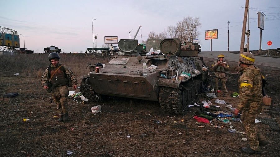 Ukrainian servicemen are seen next to a destroyed armoured vehicle, which they said belongs to the Russian army, outside Kharkiv, Ukraine. Representative image. Credit: Reuters Photo