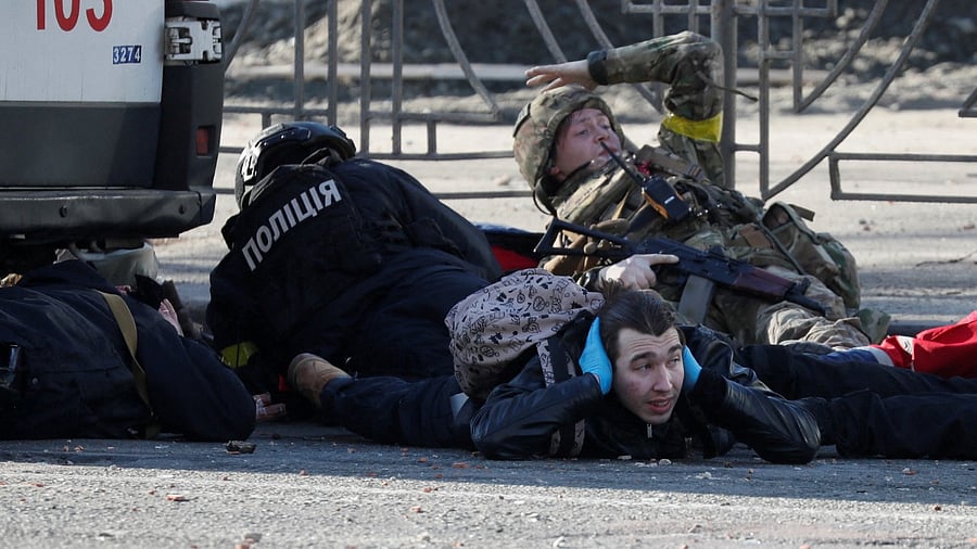People take cover as an air-raid siren sounds in Kyiv. Credit: Reuters Photo