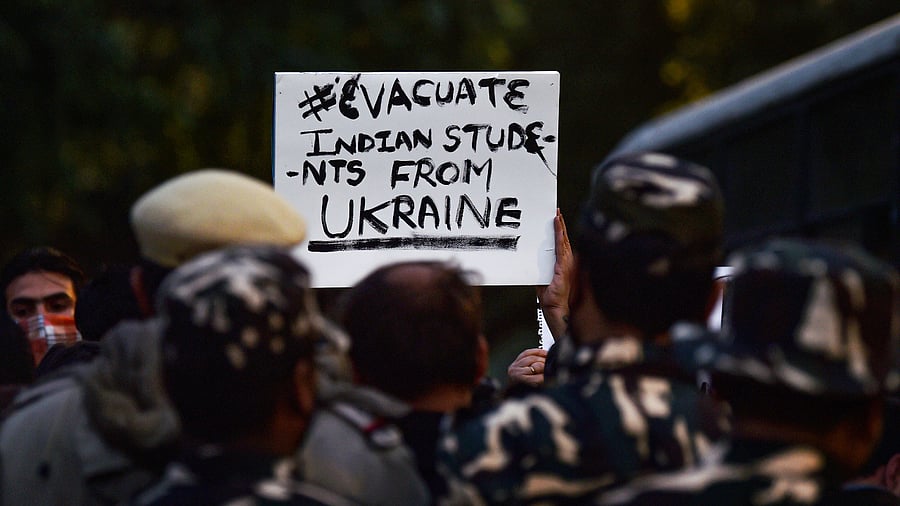 Family members of students stranded in crisis-hit Ukraine display a placard during a protest near the Embassy of the Russian Federation amid Ukraine-Russia conflict. Credit: PTI Photo