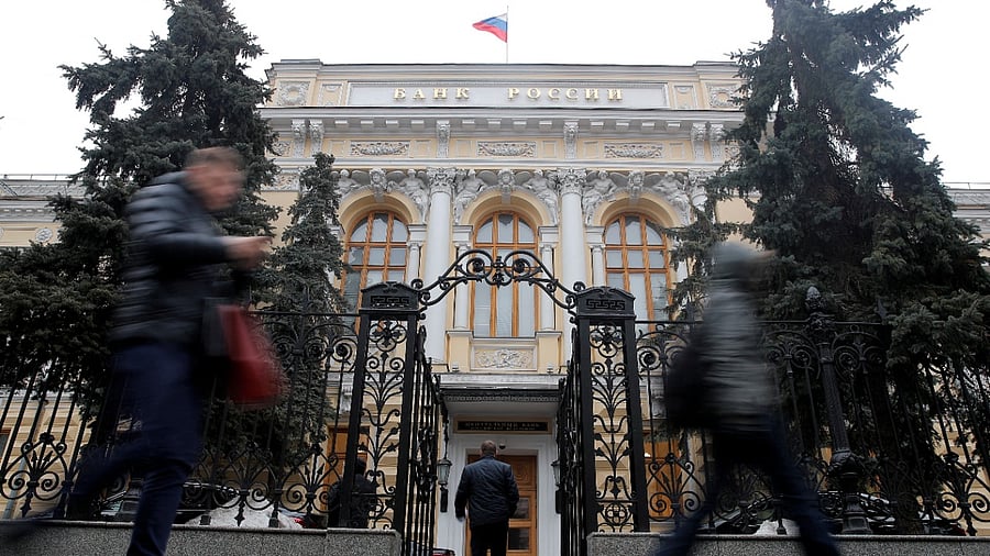 People walk past the Central Bank headquarters in Moscow. Credit: Reuters File Photo