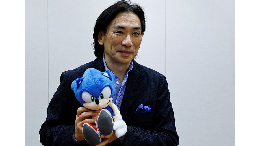 Sega Corp's Co-Chief Operation Officer Shuji Utsumi poses with 'Sonic the Hedgehog' toy. Credit: Reuters Photo