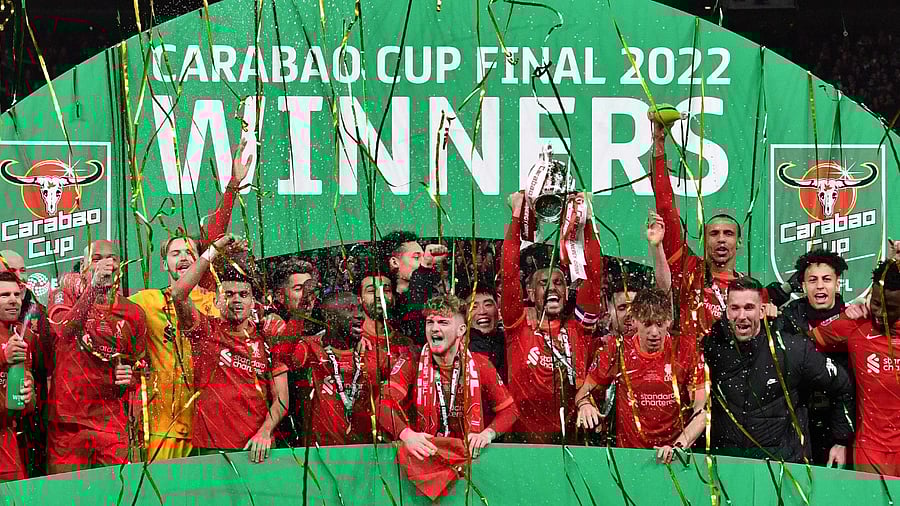 Liverpool players celebrate with the winner's trophy after the English League Cup final football match between Chelsea and Liverpool at Wembley Stadium, north-west London. Credit: AFP Photo