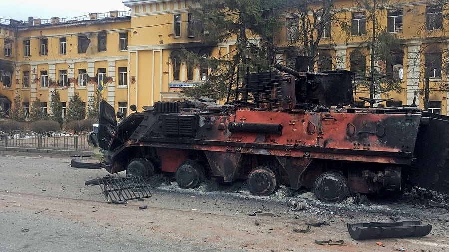 A destroyed Ukrainian armoured personnel carrier vehicle is seen in front of a school in Kharkiv. Credit: Reuters Photo
