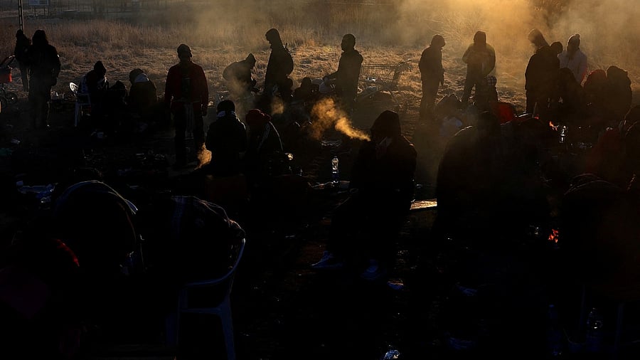 Refugees brave the cold in a frozen field after they fled from Ukraine because of the Russian invasion at the border checkpoint in Medyka. Credit: Reuters Photo
