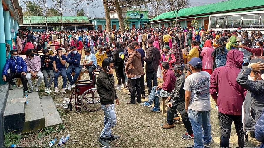 Voters wait outside a polling booth during the first phase of Manipur state elections in Imphal, on Monday. Credit: IANS Photo