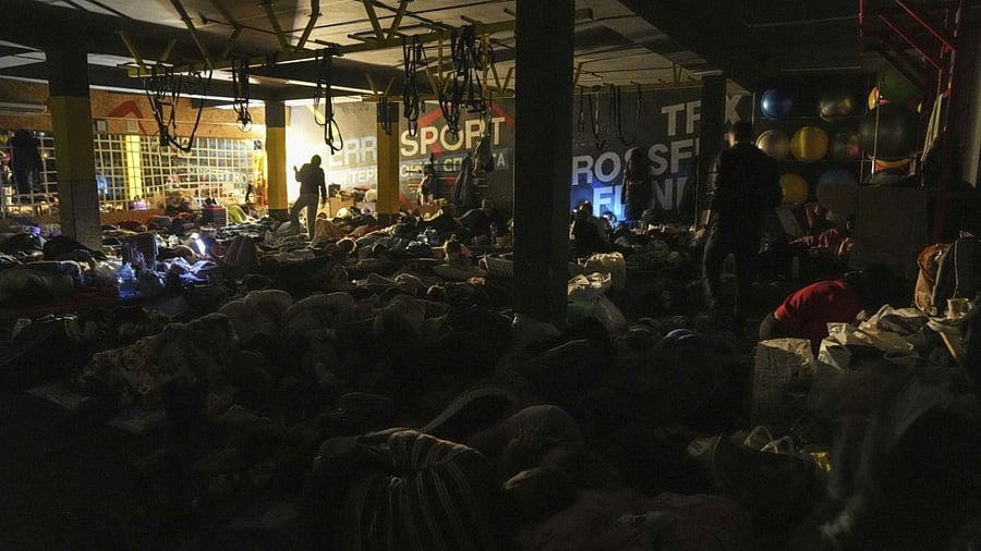 People prepare for the night in the improvised bomb shelter in a sports center, which can accommodate up to 2000 people, in Mariupol, Ukraine, late Sunday, Feb. 27, 2022. Credit: AP Photo