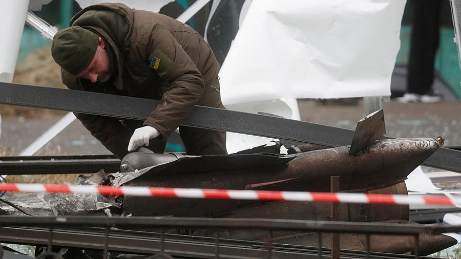 A police officer inspects the remains of a missile that landed on a street in Ukraine. Credit: Reuters Photo