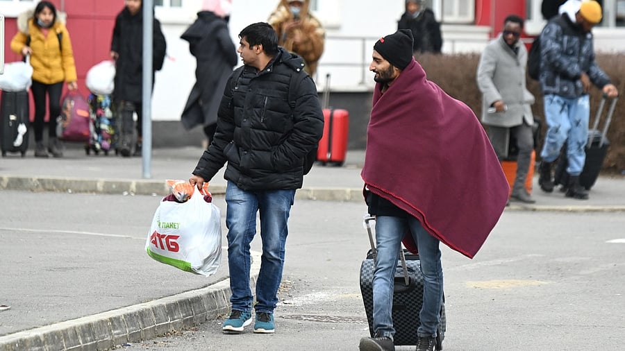 Fleeing from the Ukrainian capital Kyiv, university students from India cross the border by foot in Barabas, Hungary. Credit: AFP File Photo