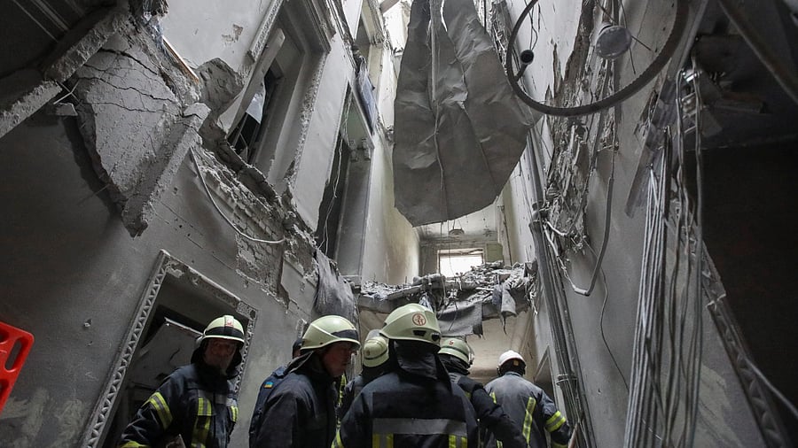 Rescuers remove debris in the regional administration building, which city officials said was hit by a missile attack, in central Kharkiv. Credit: Reuters Photo
