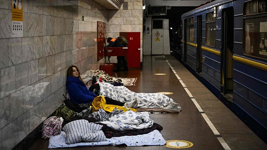 A woman sits in an underground metro station used as bomb shelter in Kyiv. Credit: AFP Photo