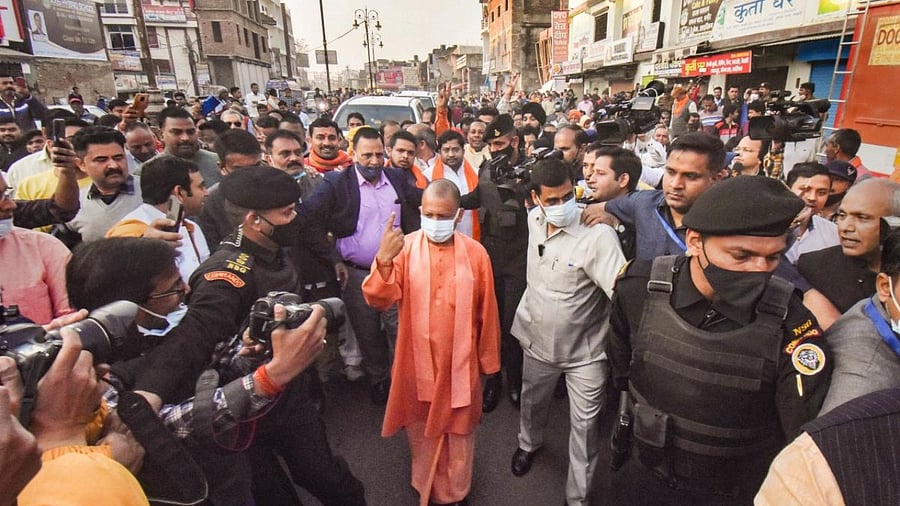 UP Chief Minister Yogi Adityanath shows his inked finger as he leaves after casting his vote at a polling station during the 6th phase of Assembly elections, in Gorakhpur. Credit: PTI File Photo
