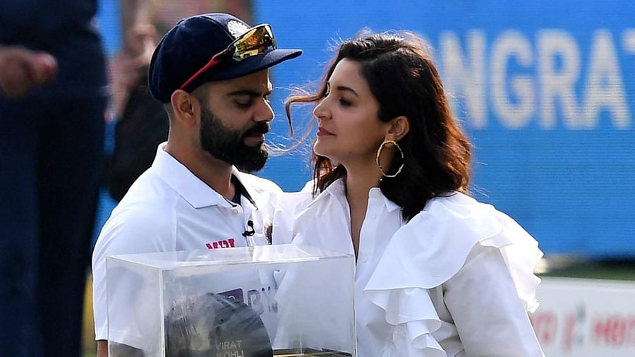 Indian cricketer Virat Kohli with wife Anushka poses for photographs after being honoured by the Punjab Cricket Association (PCA) for becoming the 13th Indian cricketer to play 100 Test matches, at IS Bindra PCA Stadium, Mohali, Friday, March 4, 2022. Credit: PTI Photo