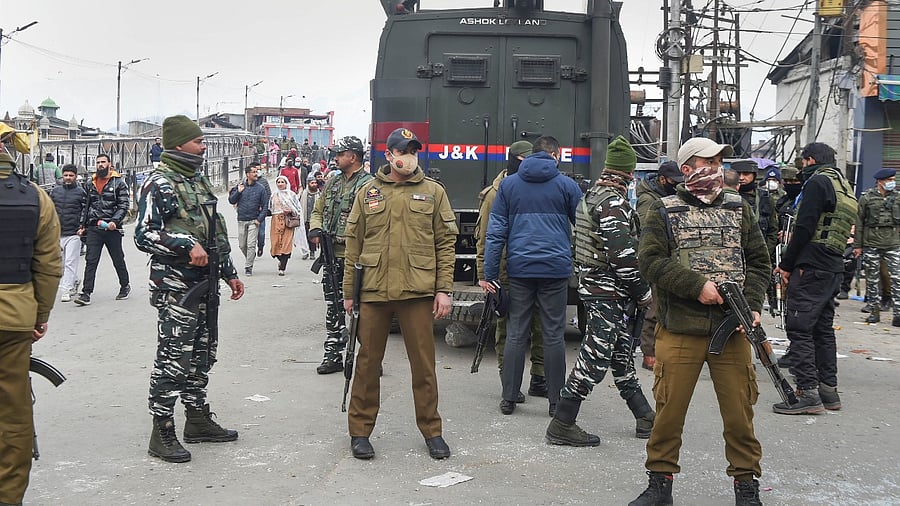 Security personnel stand guard after a grenade attack by militants at Hari Singh High Street in Srinagar. Credit: PTI Photo