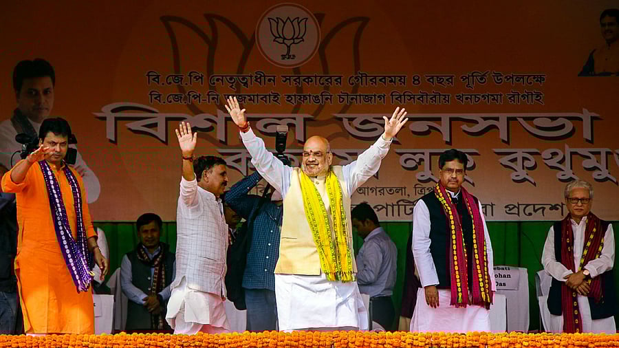 Union Home Minister Amit Shah and Tripura CM Biplab Kumar Deb wave at supporters. Credit: PTI Photo
