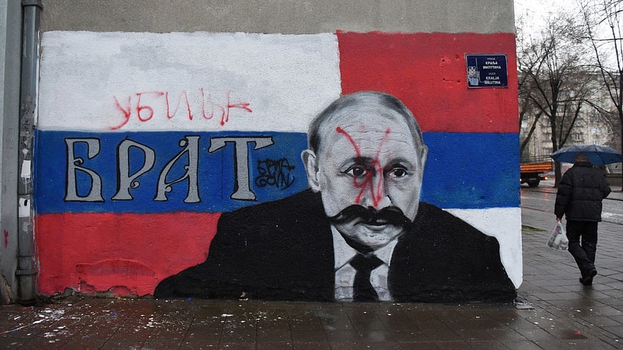 A vandalised mural of Russian President Vladimir Putin. Credit: Reuters Photo