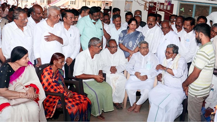 Opposition leader Siddaramaiah consoles the parents of Naveen Shekharappa Gyanagoudar, a medical student who was killed in a Russian shelling in Ukraine, at Chalageri in Ranebennur taluk, Haveri district, on Wednesday. Credit: DH photo