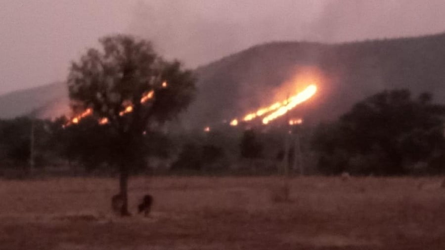 The wildfire in Kappatagudda hill range, which was first spotted on Friday, continued to rage till late Saturday night, near Dambal in Gadag district. Credit: Special arrangement