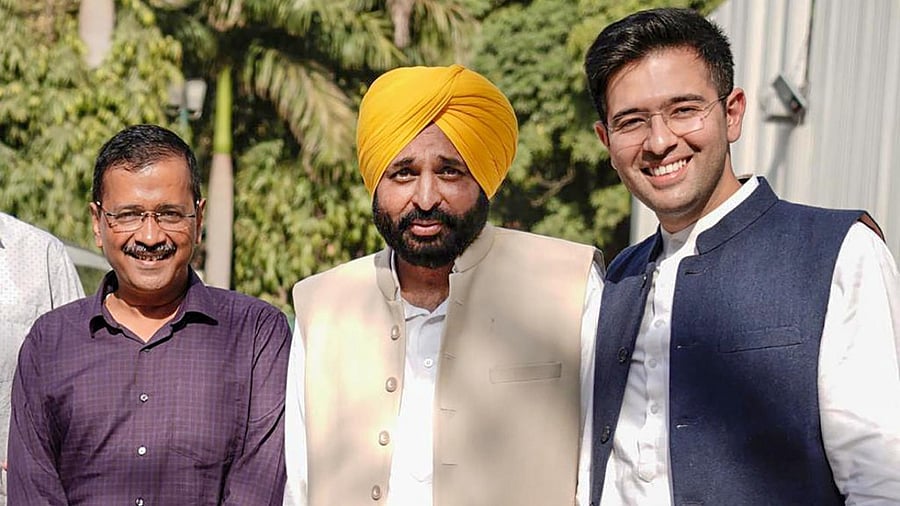 AAP's Punjab Chief Minister-elect Bhagwant Mann with Delhi CM and party convenor Arvind Kejriwal and party leader Raghav Chadha in New Delhi, Friday, March 11, 2022. Credit: PTI Photo