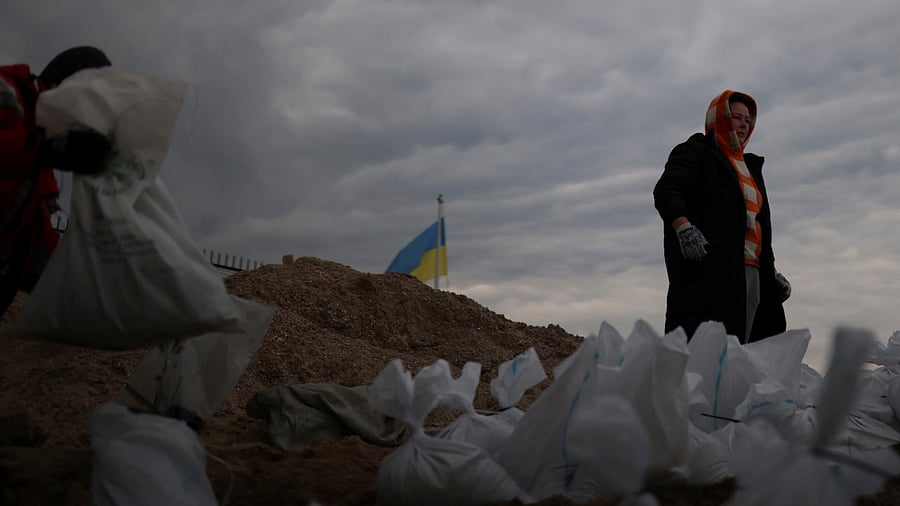 Locals carry sandbags, filled with sand from Sobachyy beach, to bolster the city's defences, as Russia's invasion of Ukraine continues in Odessa, Ukraine, March 14, 2022. Credit: Reuters Photo