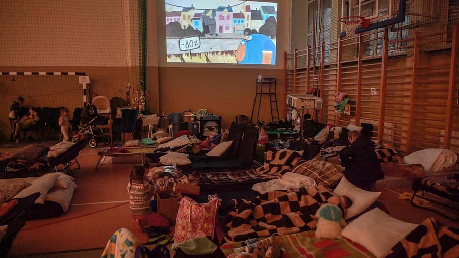 A child watches animation films provided by an NGO in the first reception center for refugees in Medyka, southeastern Poland, at the Polish-Ukrainian border. Credit: AFP Photo
