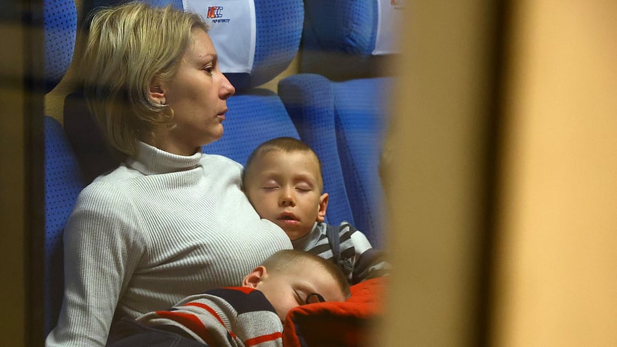 Refugees sit inside a train to Berlin at the main train station, after fleeing the Russian invasion of Ukraine in Krakow, Poland. Credit: Reuters Photo