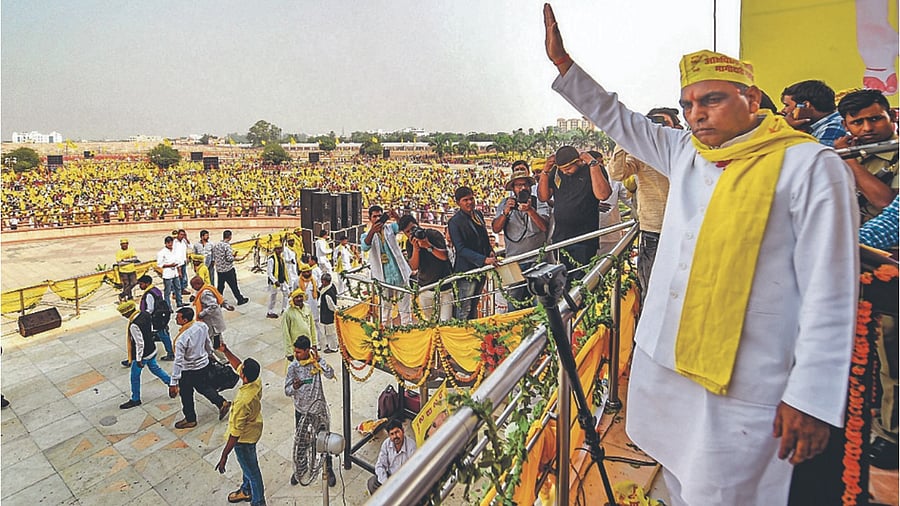 SBSP chief Om Prakash Rajbhar waves to the crowd during a rally. Credit: PTI File Photo