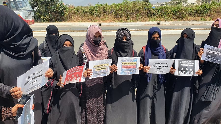 Students holding placards outside IDSG Government College in Chikkamagaluru. Credit: DH photo