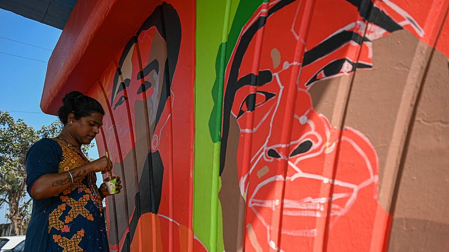 In this photo taken on February 19, 2022, transgender woman artist Ayesha Koli paints a mural on a pillar of a flyover in Mumbai. Credit: AFP Photo