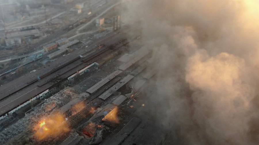 Multiple explosions and rising smoke are seen around an industrial compound, in Mariupol. Credit: Reuters Photo