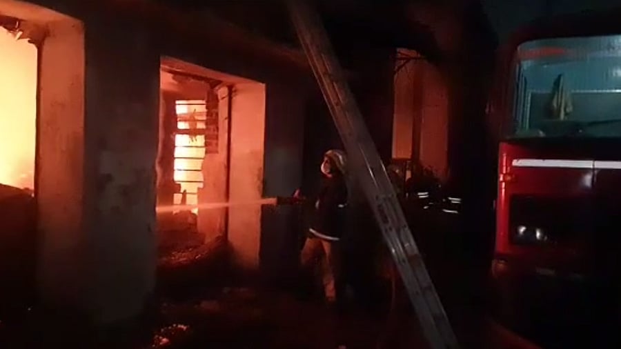 A firefighter douses flames at a scrap godown that caught fire in the IDH Colony in Secunderabad. Credit: Special arrangement