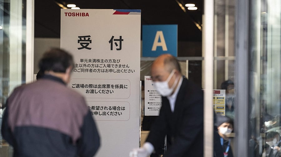 People arrive for a shareholders meeting of Toshiba in Tokyo. Credit: AFP Photo