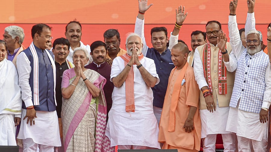Prime Minister Narendra Modi with BJP leader Yogi Adityanath, during the latter's swearing-in ceremony as Uttar Pradesh Chief Minister, at Atal Bihari Ekana Stadium in Lucknow, Friday, March 25, 2022. Credit: PTI Photo