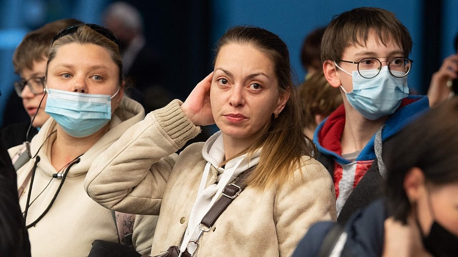 Refugees from Ukraine wait to be registered by the Federal Police after landing at the airport in Frankfurt am Main, Western Germany. Credit: AFP Photo