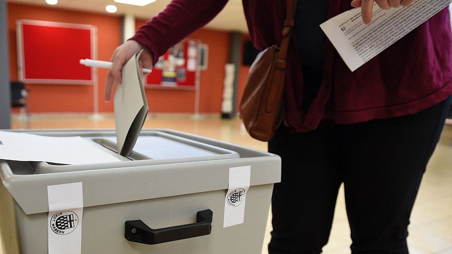 A man casts his ballot at a polling station in Wadern, western Germany. Credit: AFP Photo