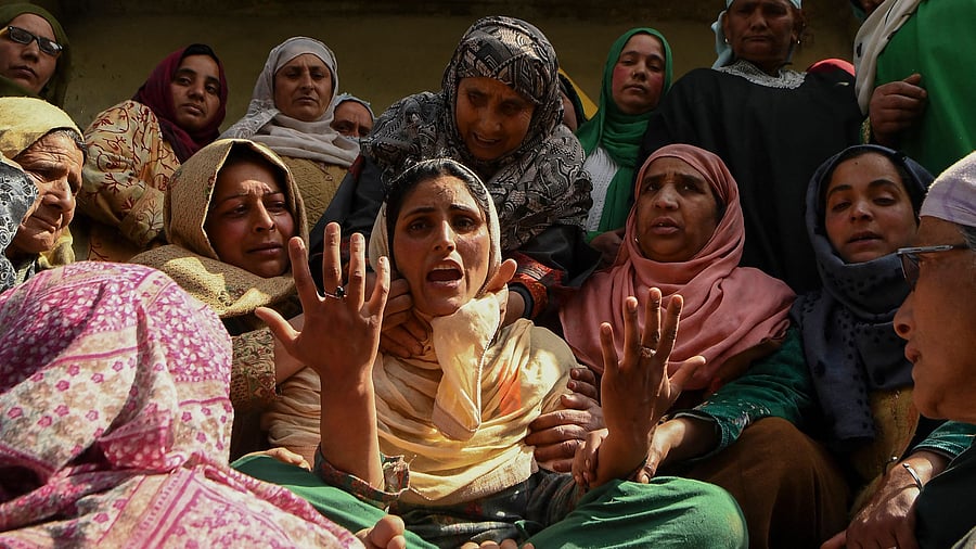 Villagers and relatives mourn during the funeral of a slain policemen and his brother at Chattabugh village of central Kashmir’s Budgam district near Srinagar. Credit: AFP File Photo