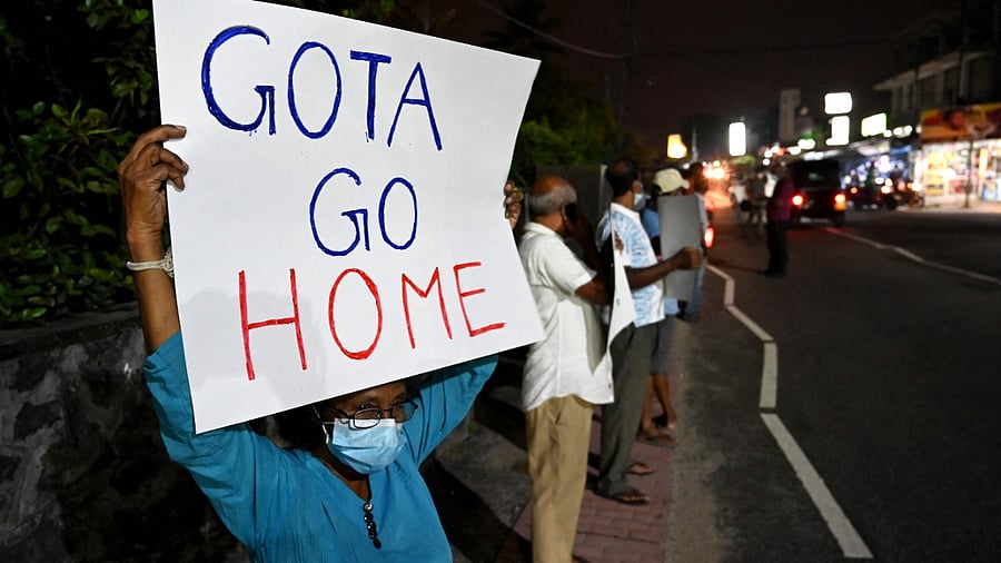 People take part in a demonstration to denounce the shortage of cooking gas, kerosene oil and other essential commodities on the outskirts of Colombo. Credit: AFP Photo
