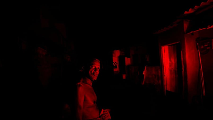 A man looks on as he waits outside his house during the power cut in Colombo, Sri Lanka March 30, 2022. Credit: Reuters Photo