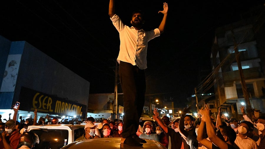 A demonstrator shouts slogans as he gathers with other protestors outside Sri Lanka President's home to call for his stepping down as the country's unprecedented economic crisis worsened in Colombo. Credit: AFP Photo