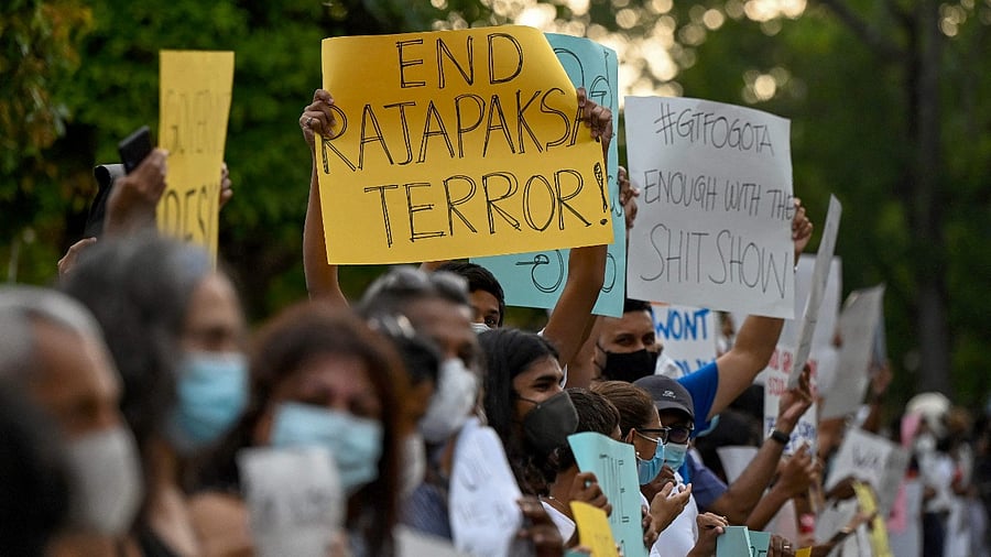Protestors hold banners and placards during a demonstration against the surge in prices and shortage of fuel and other essential commodities in Colombo. Credit: AFP Photo