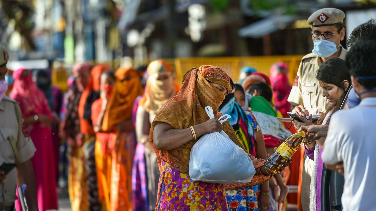 A sex worker collects ration from NGO workers during a nationwide lockdown amid the Covid-19 outbreak. Credit: PTI File Photo