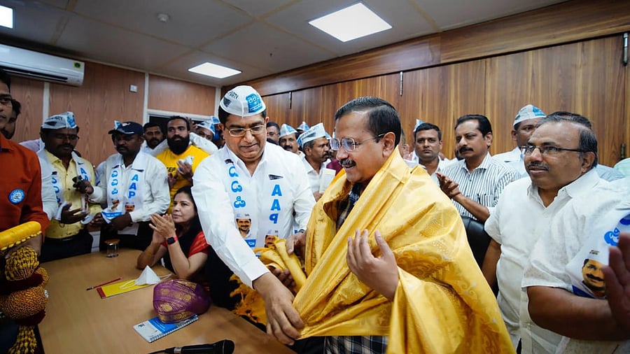 Former additional director general of Karnataka Bhaskar Rao felicitates New Delhi Chief Minister Arvind Kejriwal as the former joins Aam Aadmi Party in New Delhi on Monday. Credit: PTI Photo