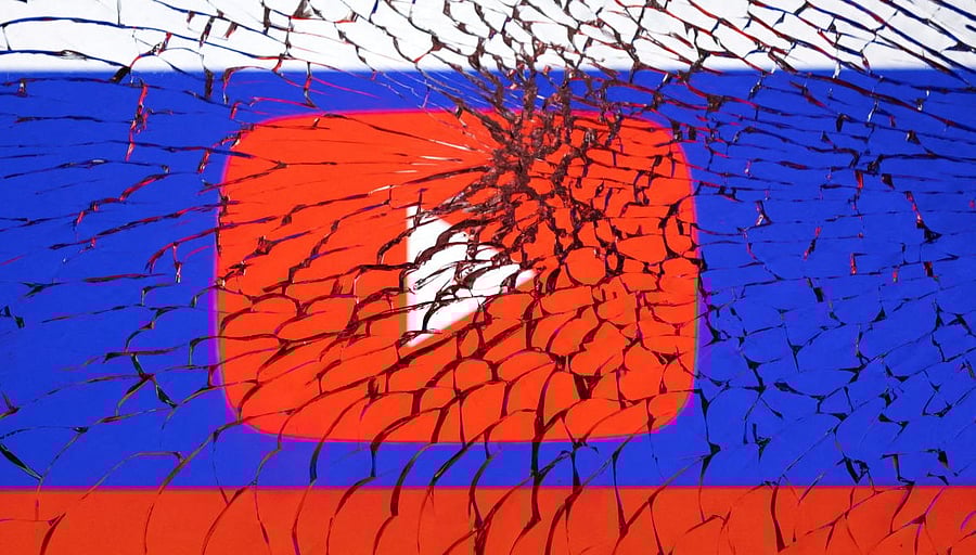 Illustration shows Youtube logo and Russian flag through broken glass. Credit: REUTERS FILE PHOTO